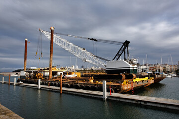 Barge and crane docked on in San Francisco on bay.