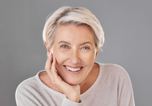 Skincare, beauty and happy senior woman or face model with healthy teeth giving a smile on a headshot studio portrait. Dental, wellness and cosmetic surgery for elderly women to stay beautiful