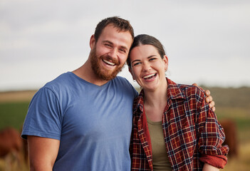Happy, carefree, and excited farmer couple standing outdoors on cattle or livestock farmland....
