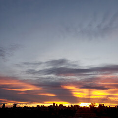Beautiful sunny sky and clouds over the horizon. Sunset background.
