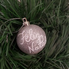 Christmas ball decorated with words. Merry Christmas. Feliz Natal. 
