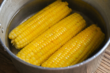 ripe corn cobs sweetcorn for food, steamed or boiled sweet corn cooked in hot pot