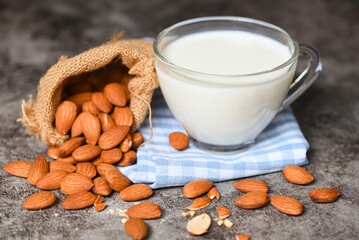 Almond milk and Almonds nuts on on sack background, Delicious sweet almonds on the table, roasted almond nut for healthy food and snack