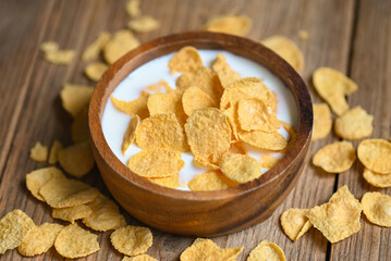 Cornflakes with milk on wooden table background, cornflakes bowl breakfast food and snack for healthy food concept, morning breakfast fresh whole grain cereal