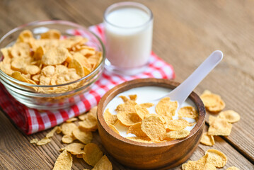 Cornflakes with milk on wooden table background, cornflakes bowl breakfast food and snack for healthy food concept, morning breakfast fresh whole grain cereal