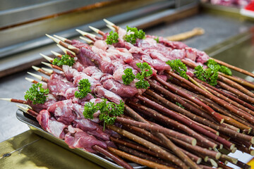 Raw lamb meat skewered, Preparing cooking on skewers.