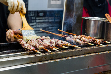 Marinated shashlik preparing on a barbecue grill over charcoal. Shashlyk (skewered meat) was originally made of lamb.