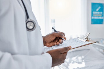 Medical, insurance and doctor filling out patient history for diagnosis at the hospital. Healthcare professional working on clipboard with paper, consulting and writing health paperwork at a clinic.