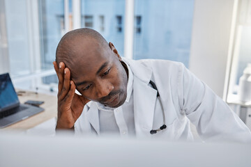 Stress, anxiety and sad doctor at work on computer, sick and headache in a hospital or clinic....