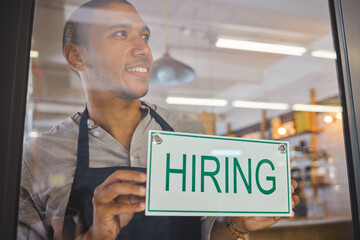 Recruitment, advertising and small business owner with hiring sign board on window or door of cafe...
