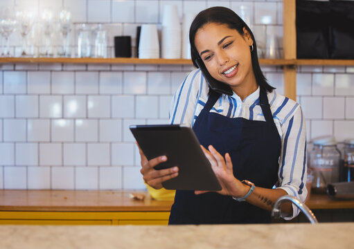 Female Cafe Or Small Business Manager On Phone Call, Reading A Digital Tablet In Her Store. Startup Business Woman, Entrepreneur Or Employee Working In A Coffee Shop Preparing Online Grocery Sales