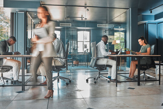 Work Process Of Busy Corporate Team Of Business People Working At Startup Marketing Company, Planning Email On Laptop And Sitting At Desk In Office. Blur Of Employees, Workers And Businesspeople