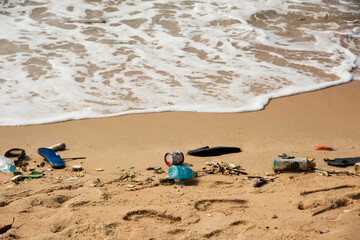 Fototapeta na wymiar garbage on the baech Beach pollution. Plastic bottles and other trash on sea beach
