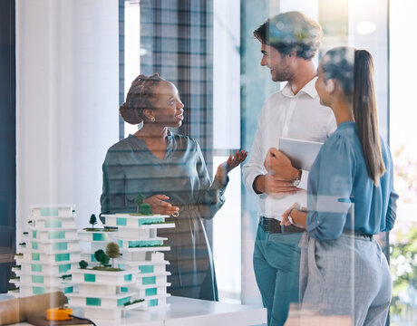 Talking architects, building engineers or designers meeting, talking and planning residential 3D model structure design. Diverse group or team of professionals sharing vision innovation in boardroom