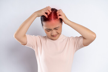 Asian woman scratching her head, with red spot standing isolated on white background.