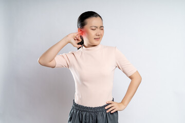 Woman itching putting a finger into her ear with red point.
