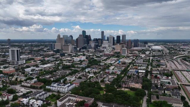Aerial view towards the Houston city skyline, in cloudy Texas, USA - approaching, drone shot