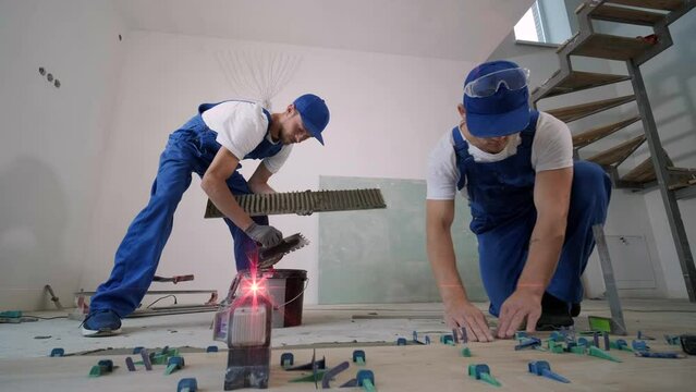 Installing ceramic floor tiles - measuring and cutting the pieces. Construction, renovation, repair apartment. Cuts tile. Tile cutting