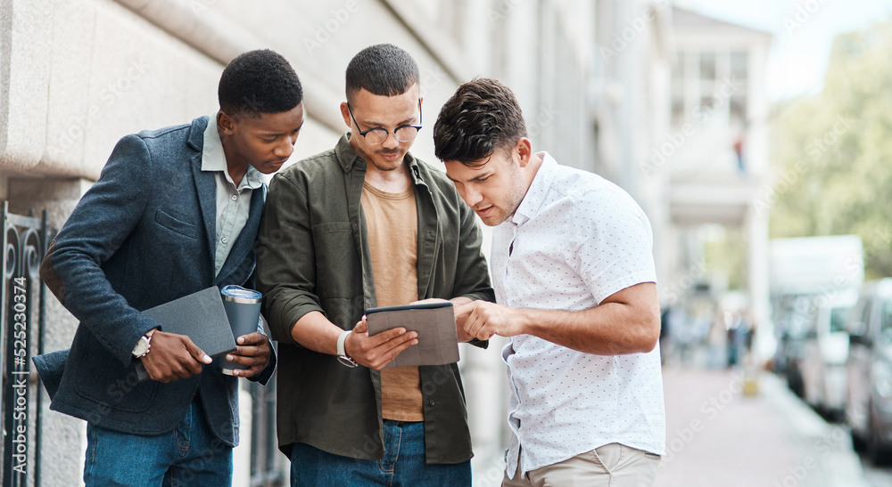 Aufkleber Team of creative designers checking a website for ux and ui while working for a startup. Group of young guys looking at a homepage on a tablet while developing a new business strategy or mission