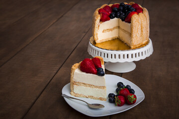 Charlotte with strawberries and blueberries french traditional dessert