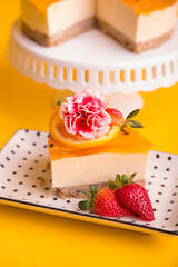 Peruvian dessert passion fruit and mango cheesecake yellow backround flower decoration