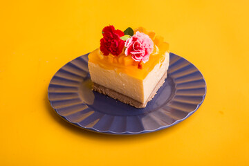 Peruvian dessert passion fruit and mango cheesecake yellow backround flower decoration