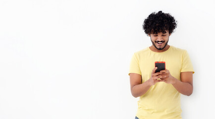 Online communication, chatting, social media concept. Happy Asian man holding smartphone, looking...