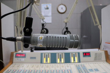 Professional microphone in radio station studio on air and mixer