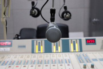 Professional microphone in radio station studio on air and mixer 