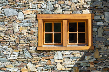 brown window on the stone wall with shadow