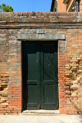 Old wooden door in a house in burano Island