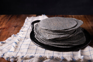 Blue Corn Tortillas. Food made with nixtamalized corn, a staple food in several American countries, an essential element in many Latin American dishes.