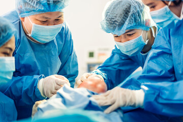 Professional anesthesiologist doctor medical team and assistant is performing baby cesarean section and hold the baby giving birth with surgery equipment in modern hospital operation room - obrazy, fototapety, plakaty