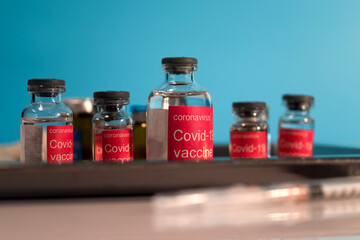 Bottle vial of Covid-19 coronavirus vaccine on  background of covid-19 quarantine