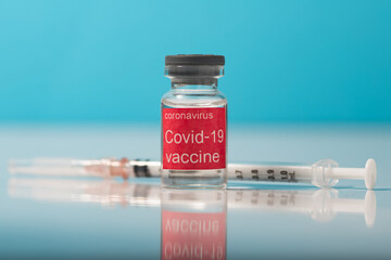 Bottle vial of Covid-19 coronavirus vaccine on  background of covid-19 quarantine