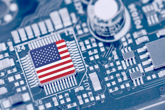 Flag of USA on a processor, CPU Central processing Unit or GPU microchip on a motherboard. Congress passes the CHIPS Act of 2022 to strengthen domestic semiconductor manufacturing, research and design