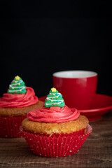 Cupcakes with Christmas tree Topper and Hot Drink on Dark Background with Copy Space Vertical
