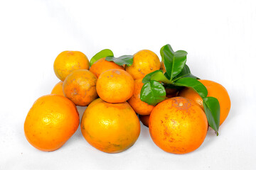 Fresh orange with leaves isolated on white cloth background