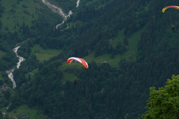 A picture with motion blur and noise effect of paragliding at Lauterbrunnen Valley