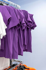 Close up of Colorful t-shirts on hangers, apparel background