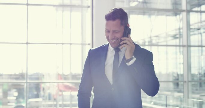 Corporate, success and businessman on a phone call with a happy client at work in a modern building. CEO, leader and business owner man or manager in communication on a smartphone at the office.