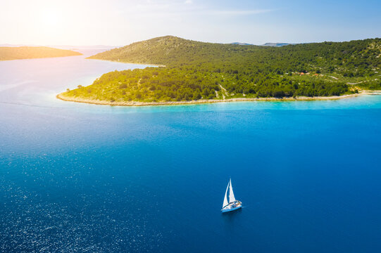 Yacht sailing at sunset during a storm. Luxury vacation at sea