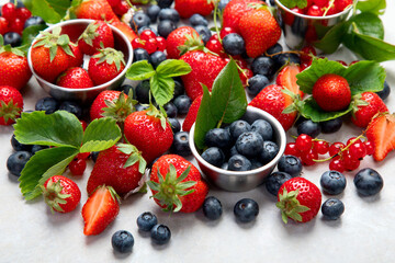 Various fresh berries on neutral background.