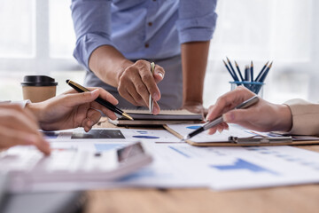 A team of Asian business advisers brainstorms a meeting to analyze and discuss the situation on the financial report in the workspace, Investment Consultant, Financial advisor accounting concept