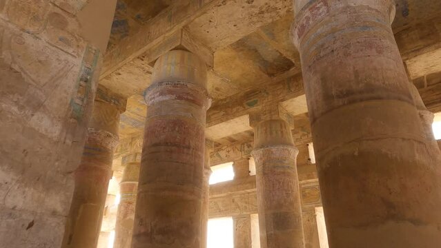 Look up on sandstone columns and ceiling with ancient drawings at Karnak Temple Complex, Luxor, Egypt