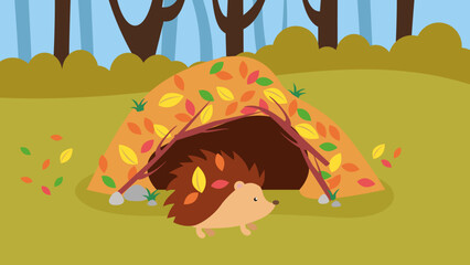 Hedgehog in the autumn park near a pile of fallen leaves