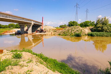 Bridge under construction over the river, concrete, construction site