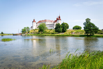 Fototapeta na wymiar Lacko castle with lake reflection