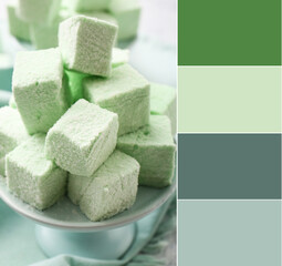 Heap of tasty mint marshmallows on dessert stand, closeup. Different color patterns