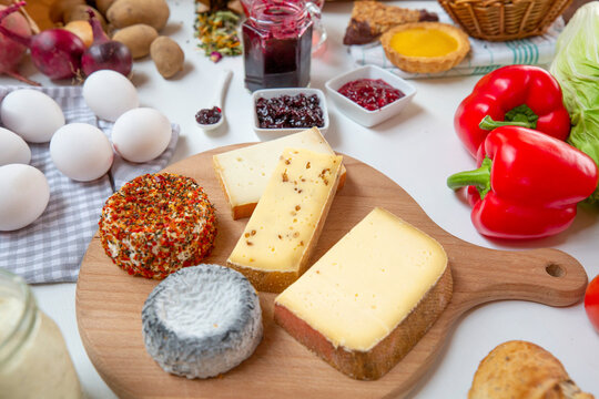 Various types of cheese on cutting board